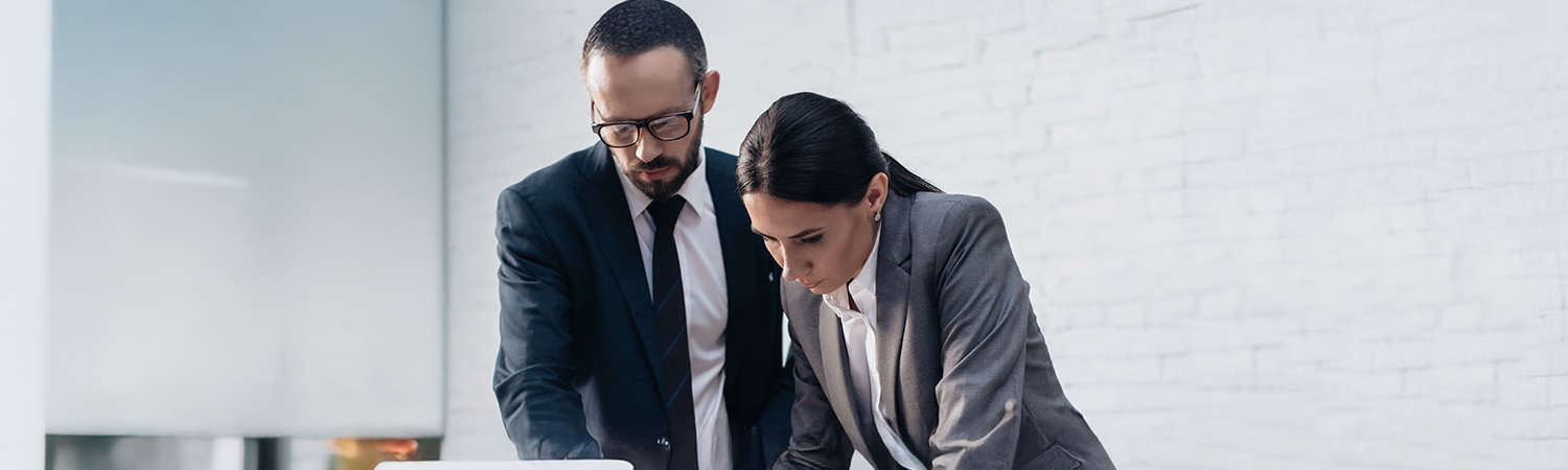 Business people reviewing information on a laptop
